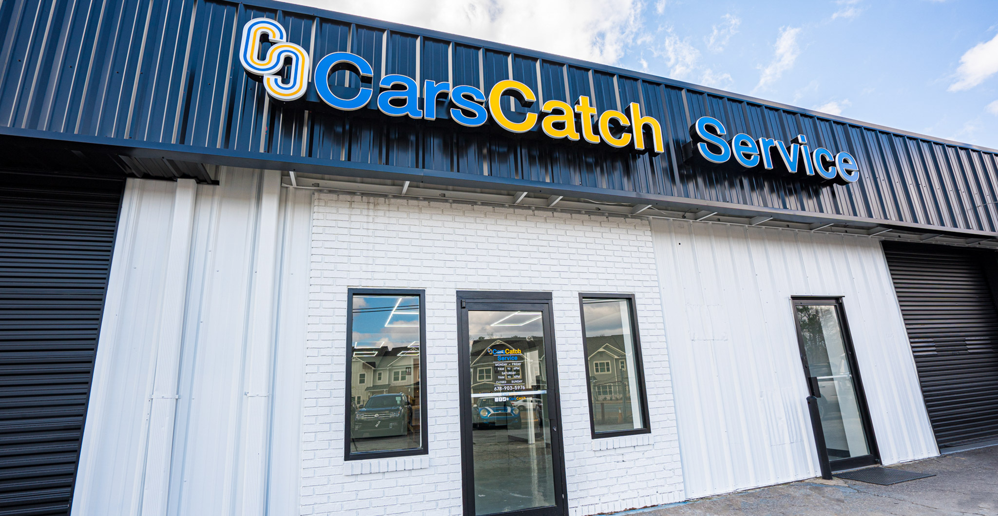 Exterior view of CarsCatch Service building with brand signage.